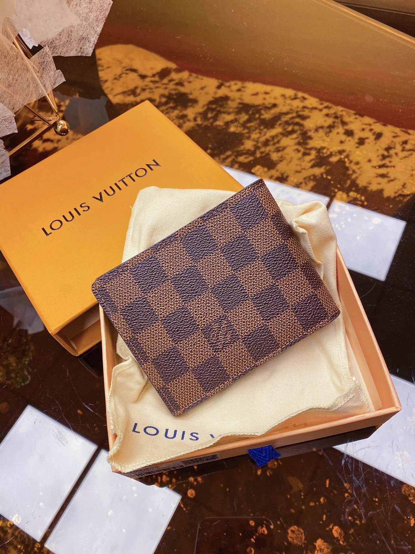 Reference image illustrating Replica Louis Vuitton Damier Graphite Canvas Wallet – Iconic LV Pattern in Grey