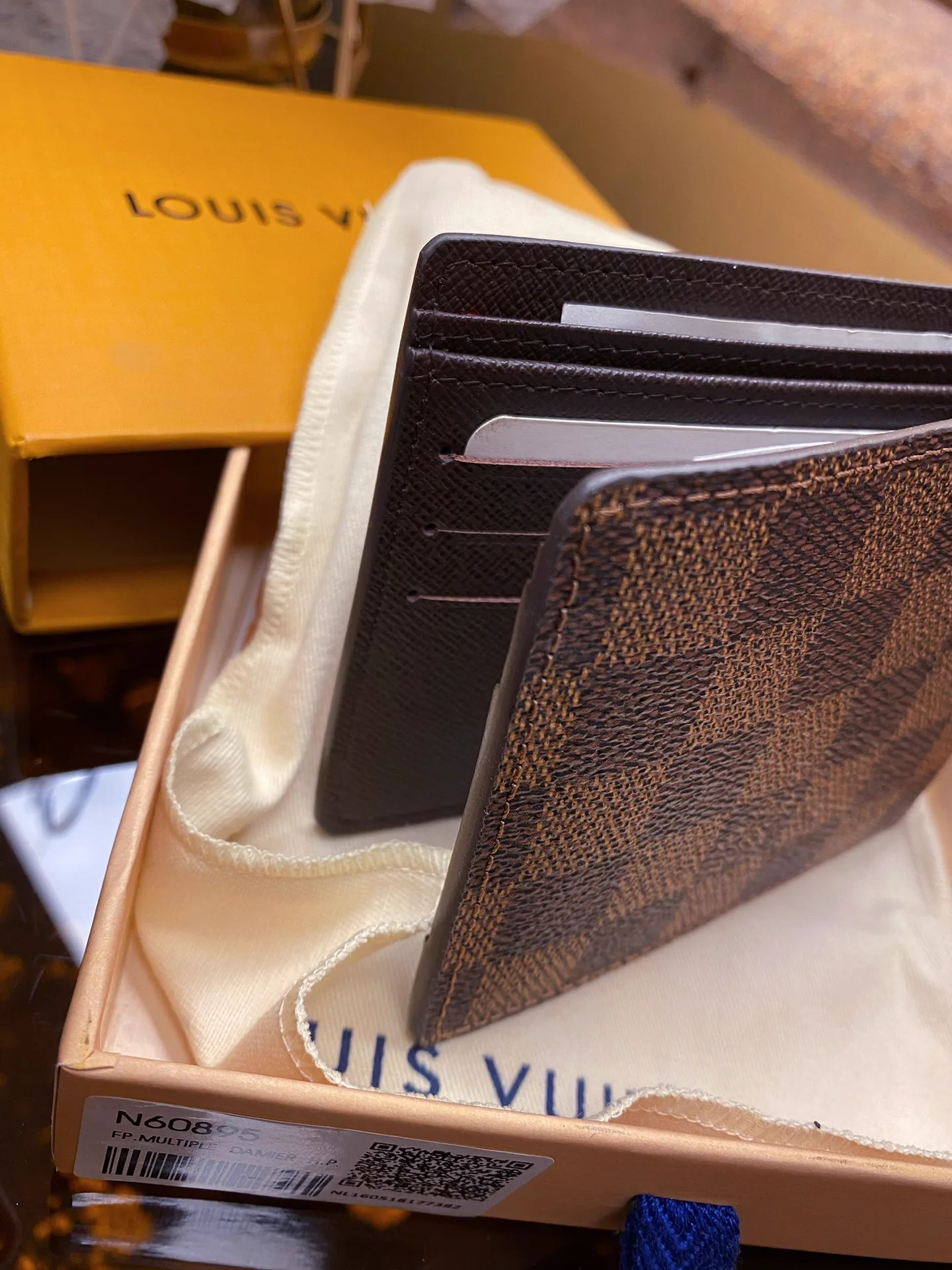 Reference image illustrating Replica Louis Vuitton Damier Graphite Canvas Wallet – Iconic LV Pattern in Grey