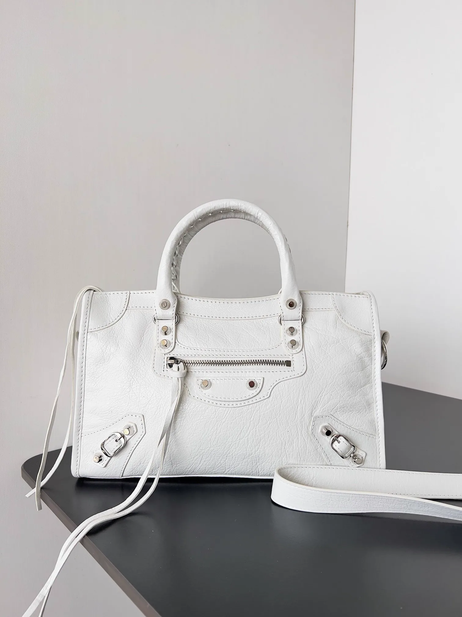 Reference image illustrating Replica Balenciaga Le City Small Bag in White Arena Lambskin: A Style Icon Reimagined