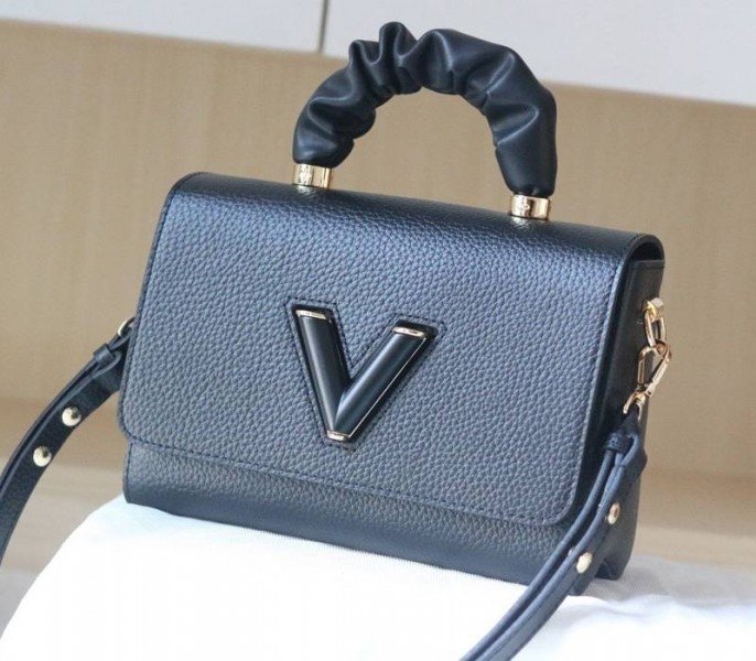 Reference image illustrating Replica Louis Vuitton Twist MM Scrunchie Handle Bag in Black Taurillon Leather