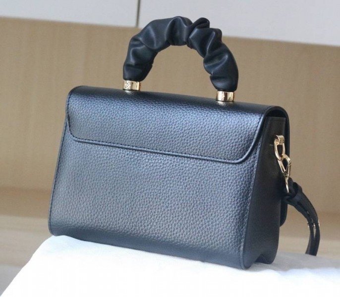 Reference image illustrating Replica Louis Vuitton Twist MM Scrunchie Handle Bag in Black Taurillon Leather