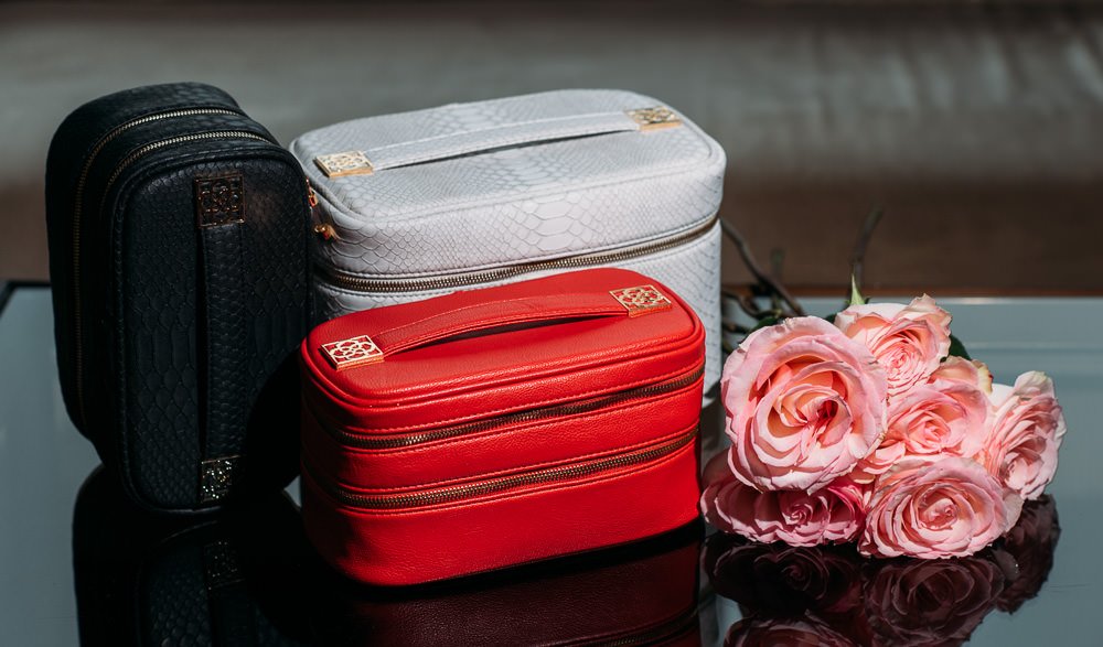 Reference image illustrating Kendra Scott Beauty Bags: Faux Python Train Cases and Cosmetic Organizers for Holiday Gifting