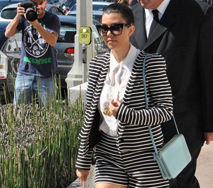 Kourtney Kardashian’s Baby Blue Celine Trio Bag Steals the Show in Striped Power Suit thumbnail