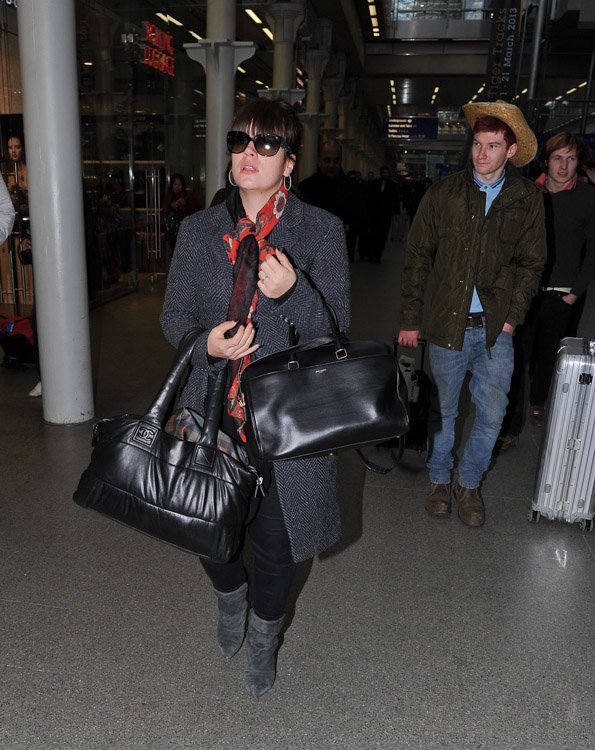 Reference image illustrating Lily Allen Doubles Up on Chanel Coco Cocoon and Saint Laurent Classic Duffel Bags at St. Pancras