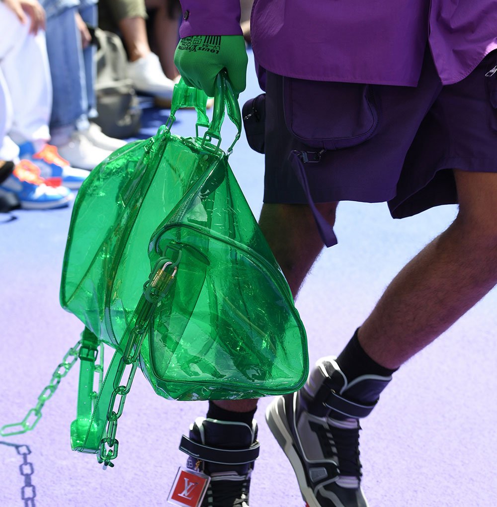 Reference image illustrating Virgil Abloh's First Louis Vuitton Collection: Transparent Keepalls, Grenade-Pin Details, and Neon Accents
